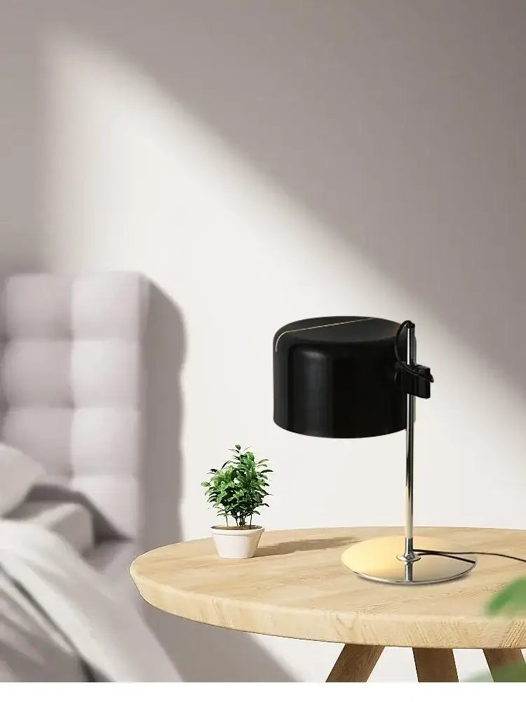 Black cylindrical designer nordic coupe table lamp with sleek chrome stand and circular base for bedroom decorbites designer nordic