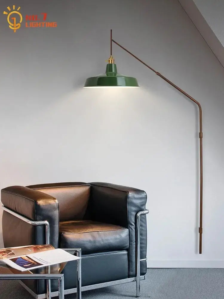 Green industrial floor lamp with curved brass arm and gold-toned hardware complementing decorbites gold black swing wall lamp