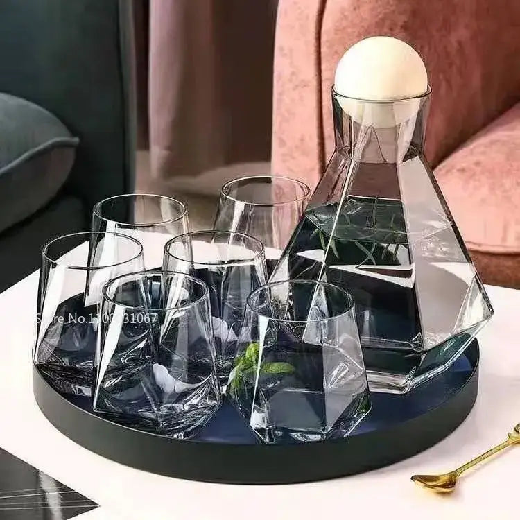 Diamond crystal glass water pitcher with geometric design and white spherical stopper with six matching faceted glasses