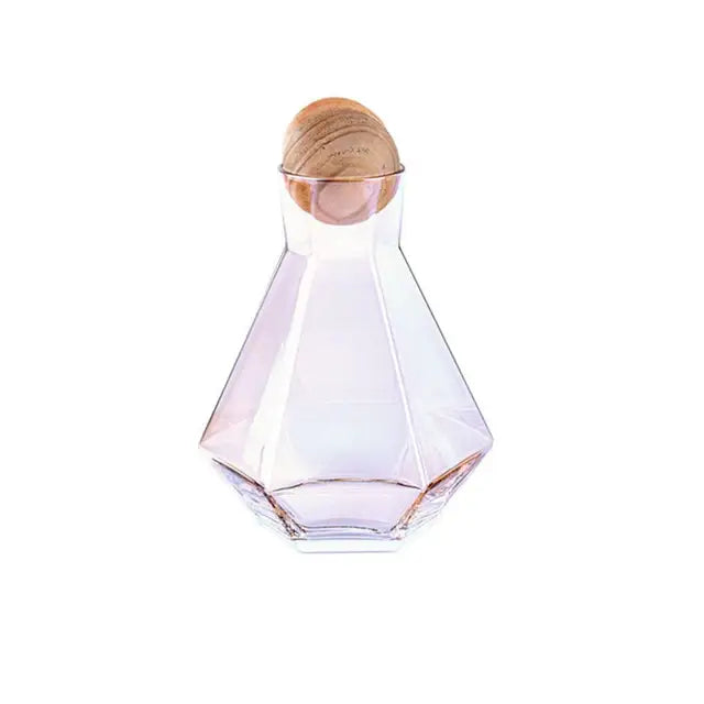 A faceted translucent diamond crystal glass water carafe with a warm-toned wooden stopper for dining room use