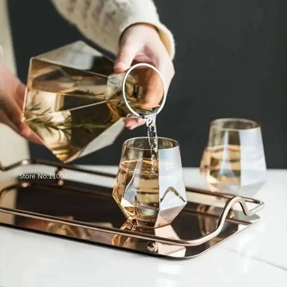 Gold-toned diamond crystal glass water decanter with metallic rim and faceted design for dining room use