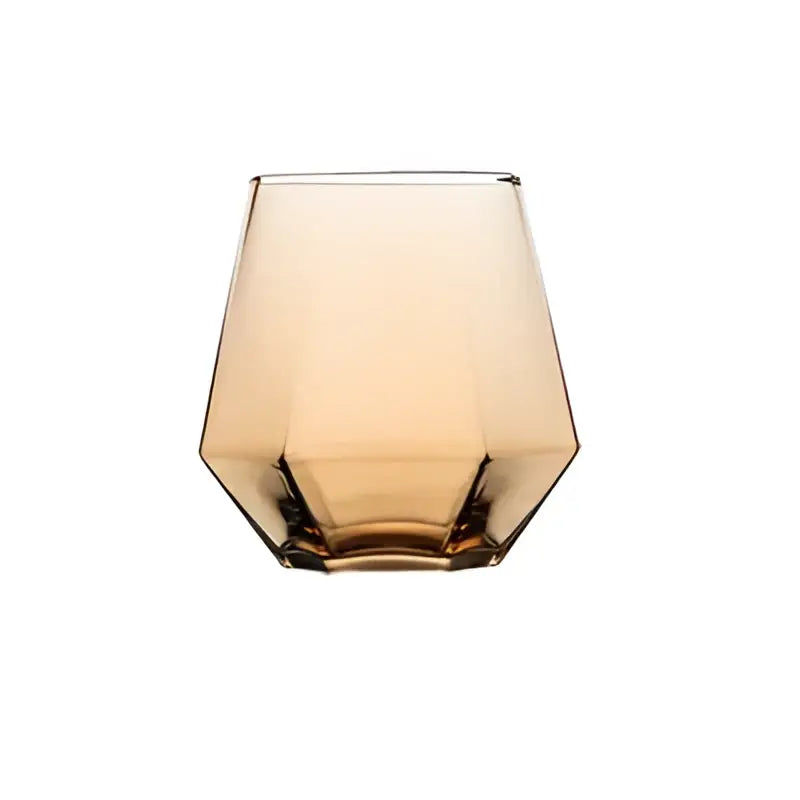 A sleek amber faceted tumbler from a diamond crystal glass water pitcher and cup set for dining room use
