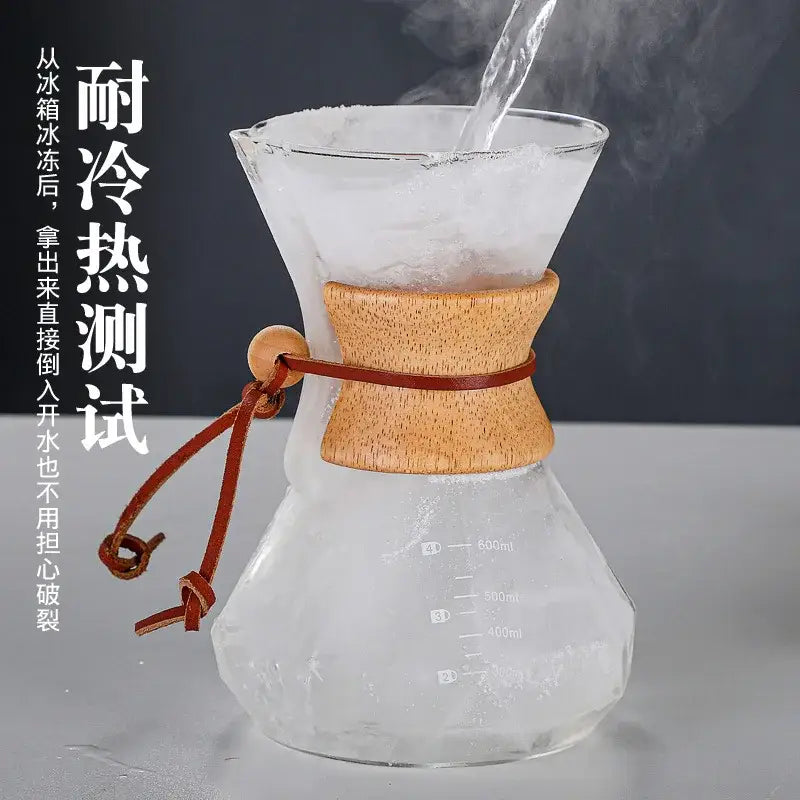 Clear glass chemex hand brew coffee maker with diamond glass hand feature and light brown wooden neck for kitchen dining