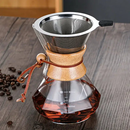 A clear glass hand brew coffee chemex with wooden collar stainless steel filter and brown leather tie for kitchen dining