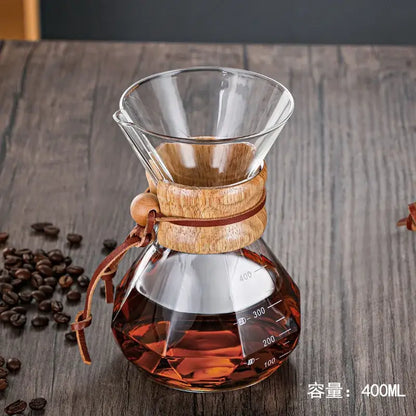 Clear glass diamond glass hand brew coffee maker with wooden collar and amber brewed coffee for kitchen dining