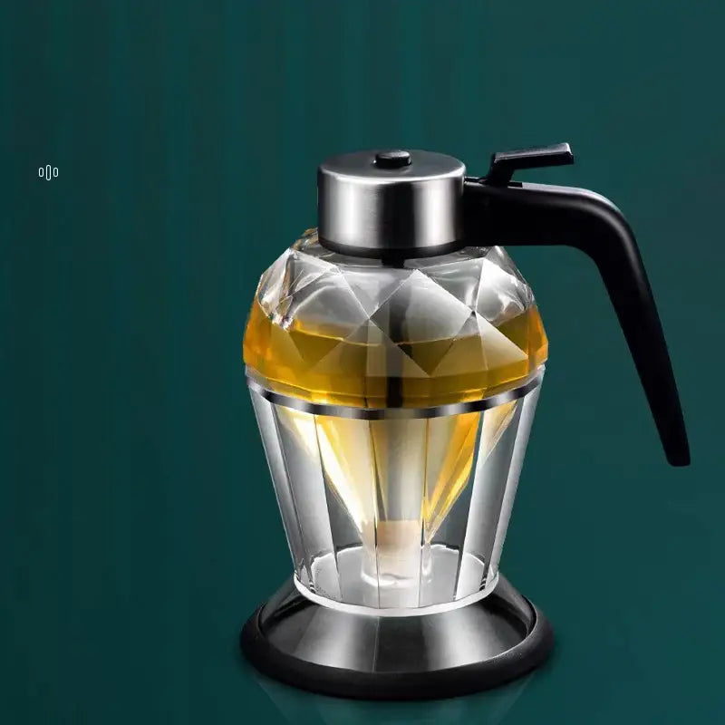Clear faceted diamond glass syrup honey dispenser with black handle and silver metal lid and base for kitchen use
