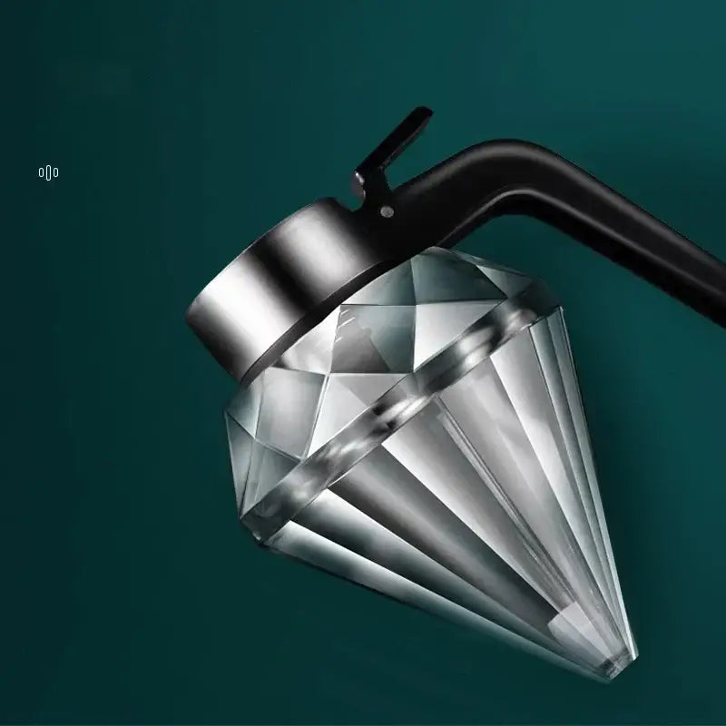 A sleek diamond glass syrup honey dispenser with a polished silver lid and black handle for kitchen use