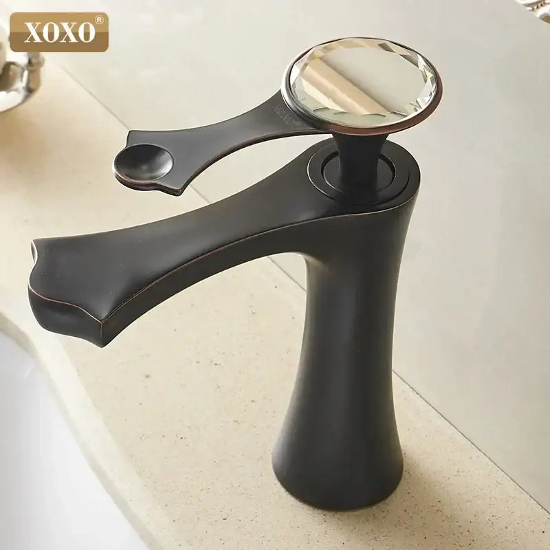 Xoxo basin faucet in diamond golden black with a sleek matte finish and a crystal handle for bathroom use