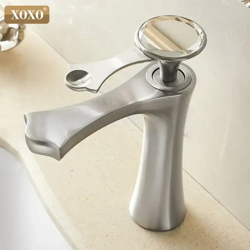 Stylish xoxo basin faucet in brushed nickel with diamond golden black accents and crystal handle for bathroom use