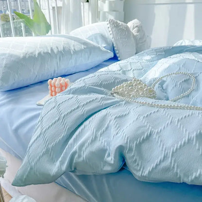 Light blue quilted jacquard duvet cover with subtle textured pattern and matching pillows for skin friendly bedding