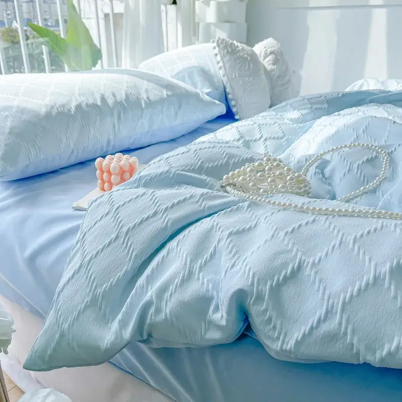 Light blue quilted jacquard duvet cover with subtle textured pattern and matching pillows for skin friendly bedding