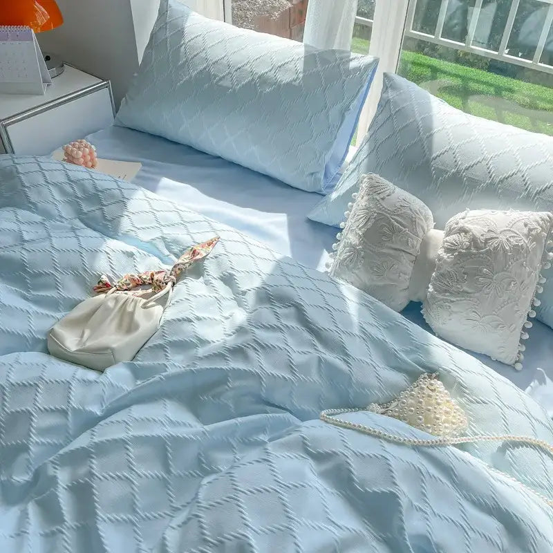 Light blue diamond jacquard duvet cover with matching pillows and white lace trimmed accents in cream bedroom set