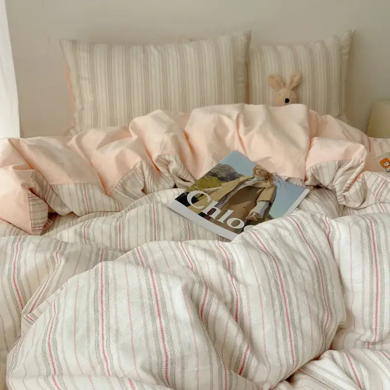 Diamond jacquard duvet cover in cream with blush pink and cream stripes featuring subtle red and gray vertical lines