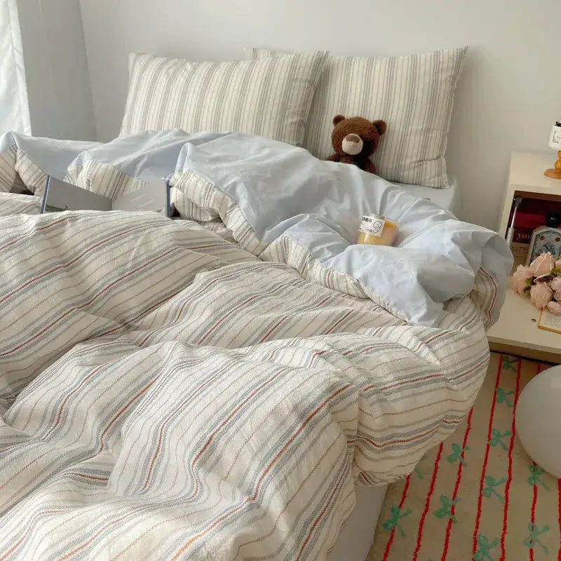 Cream-colored diamond jacquard duvet cover with soft vertical stripes in muted red and gray for skin friendly bedding
