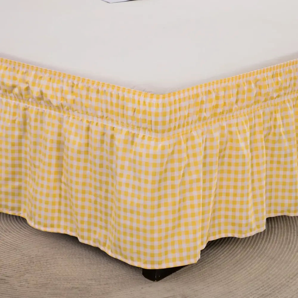 Yellow and white gingham check bed skirt with ruffled hem featuring elastic band and diamond lattice ruffled design