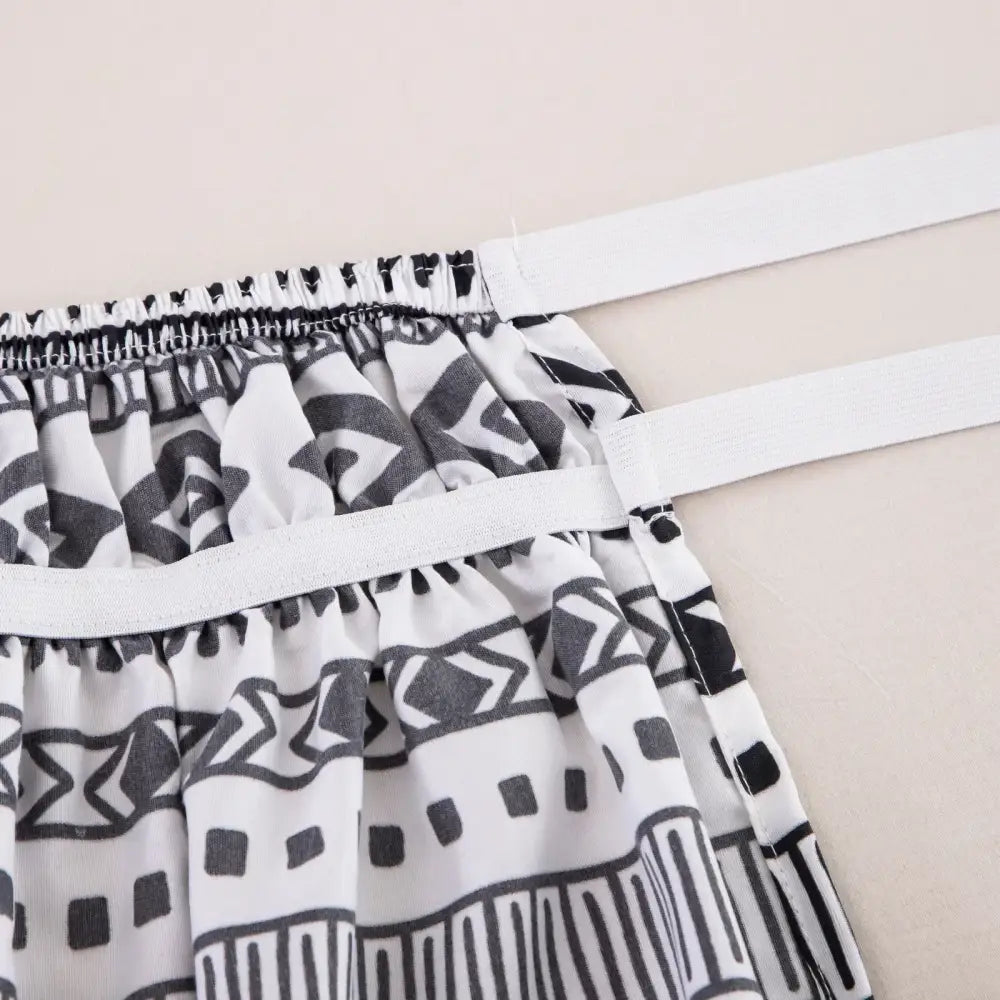 Black and white diamond lattice ruffled bed skirt with elastic band waistband for a stylish bedroom decor