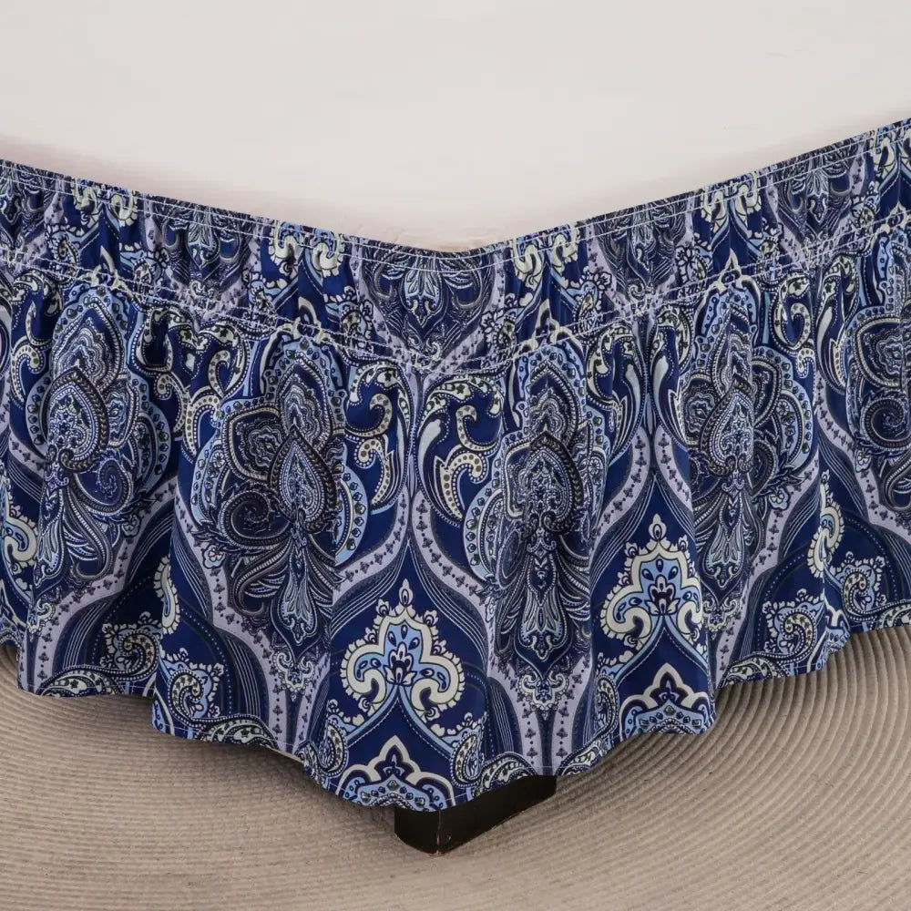 Navy blue and white paisley-patterned bed skirt with diamond lattice ruffled hem and elastic band for bedroom use