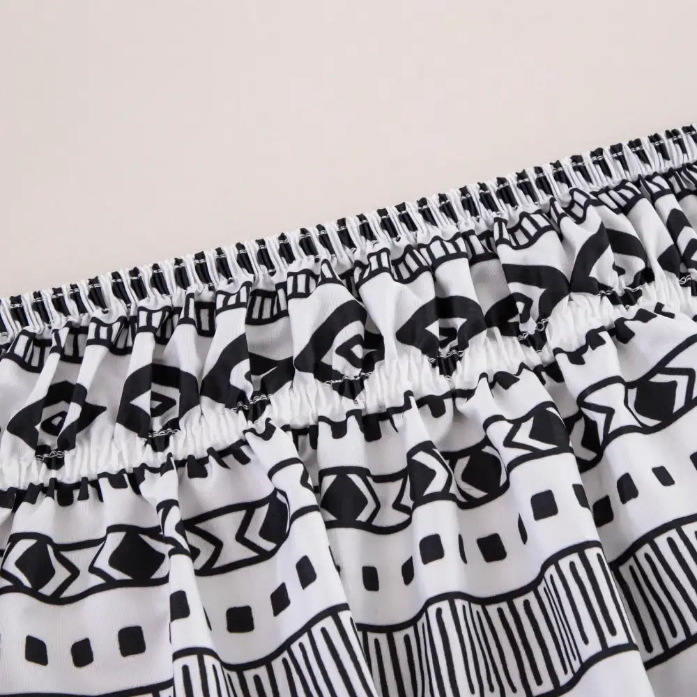 White and black geometric-patterned elastic-waist shorts featuring a diamond lattice ruffled design for stylish comfort