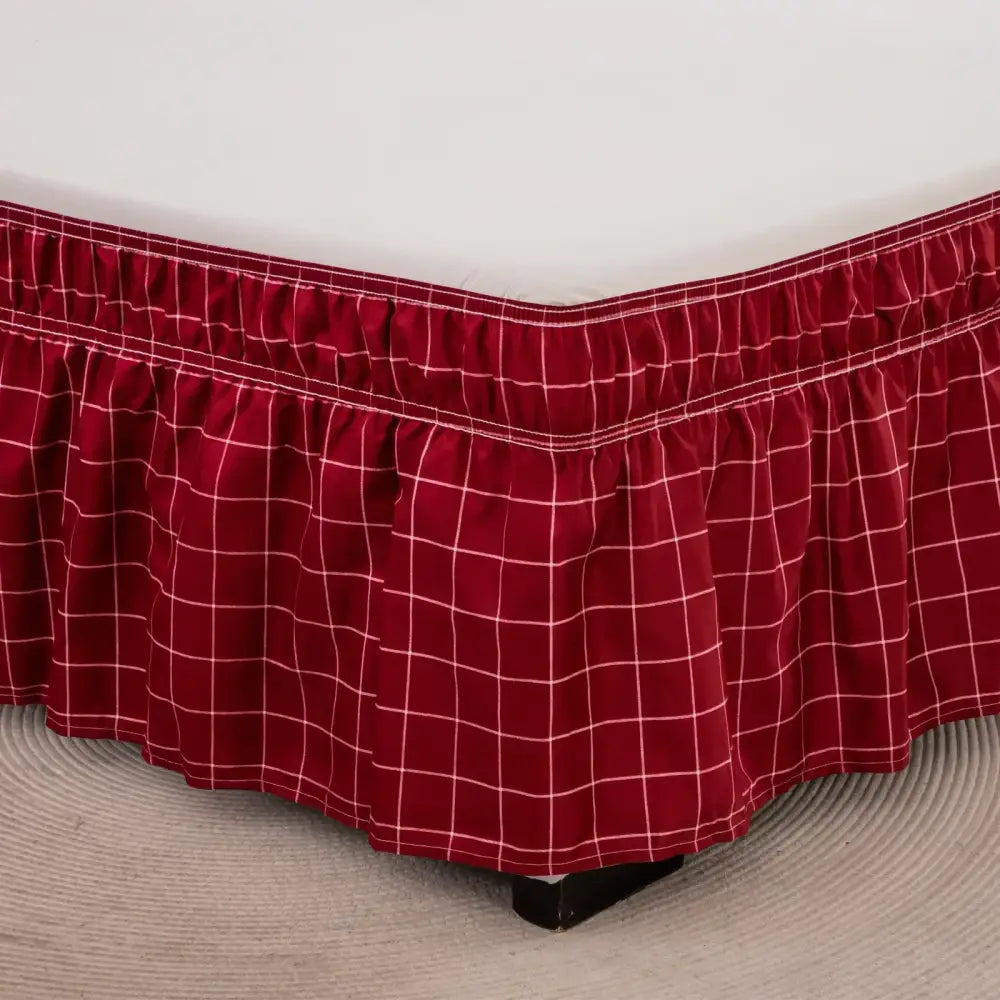 Red plaid bed skirt with white grid pattern and ruffled hem featuring diamond lattice ruffled elastic band design