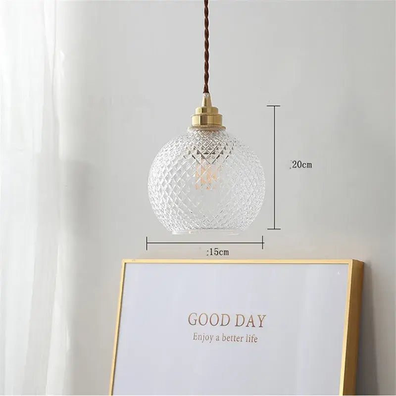 Clear glass ball led pendant light with diamond-cut pattern brass hardware and twisted brown cord for dining room decorbites