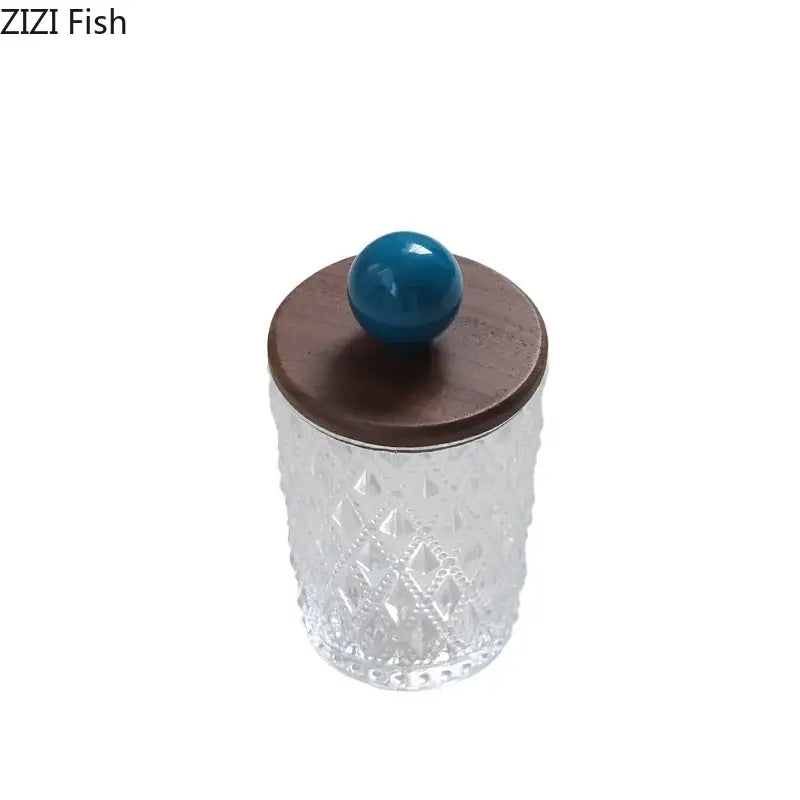 Diamond pattern glass jewelry jar with textured clear glass and a walnut lid topped by a colorful ceramic ball knob