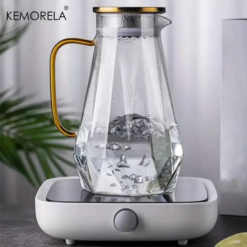Clear glass teapot with diamond texture design and gold-toned handle and lid in a glass teapot set for dining room