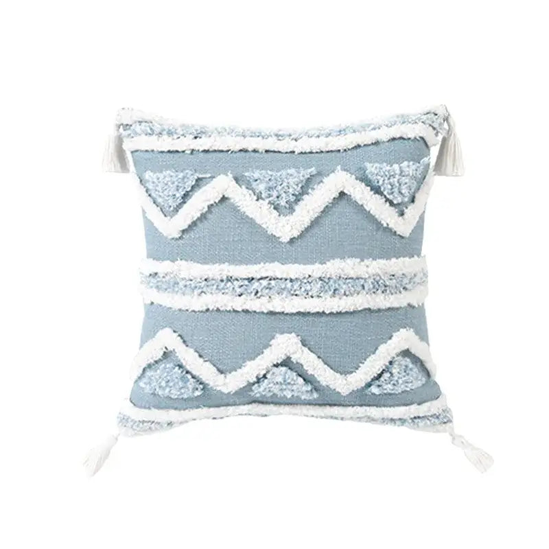 Light blue tufted blue cushion cover with white diamond patterns and tassels for living room decor