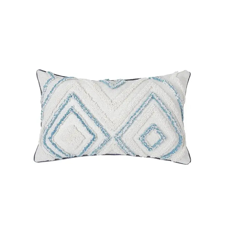 A rectangular white cushion cover with diamond tufted blue geometric patterns and a dark gray border for living room use