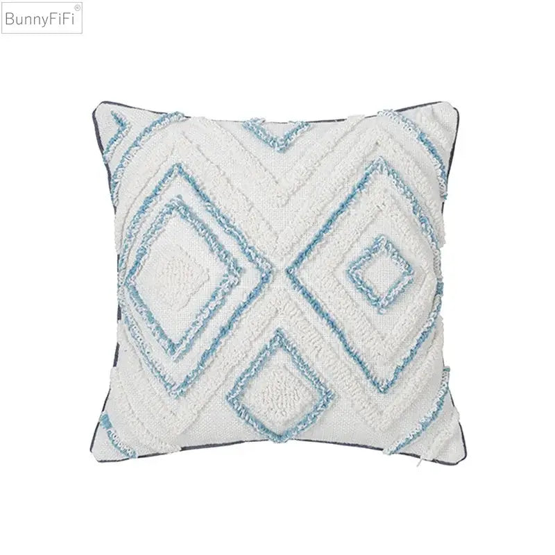 White textured throw pillow with light blue geometric embroidery and dark gray piping diamond tufted blue cushion cover