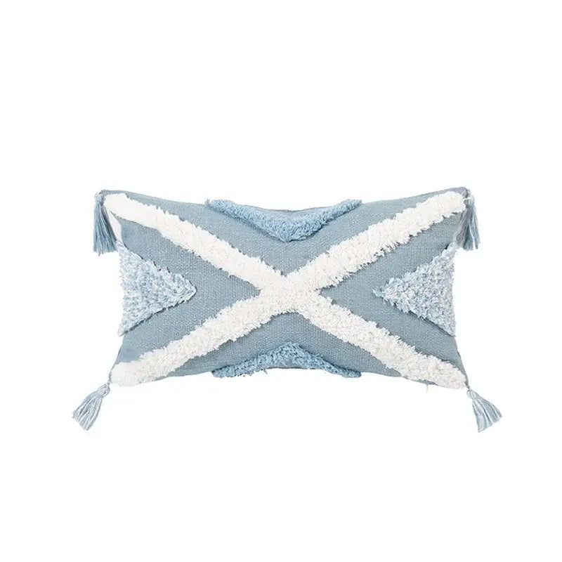 Light blue diamond tufted blue cushion cover with white woven cross accents and tassels for living room use