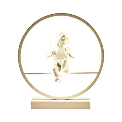 Dimbable angel table lamp featuring a translucent white cherub with outstretched wings in a softly lit circular frame