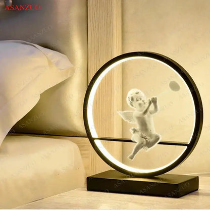 A sleek black dimmable angel table lamp with a white translucent cherub in glowing ring for bedroom decor