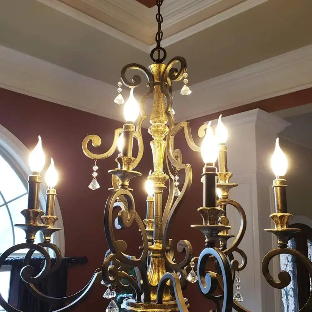 Antique brass dining room chandelier with ornate scrollwork crystal droplets and decorbites dimmable led candle light bulbs