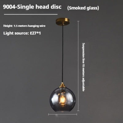 9004-single head disc pendant light with smoked glass shade and brass hardware.