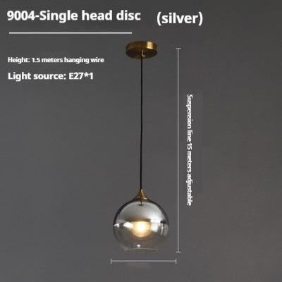 Silver globe pendant light with gold accents and adjustable suspension wire.