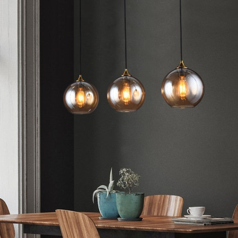 3-light smoked glass pendant light with brass accents ideal for dining room featuring a 3-head disc design
