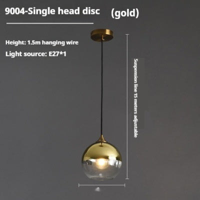 Gold and clear glass pendant light with adjustable suspension line.