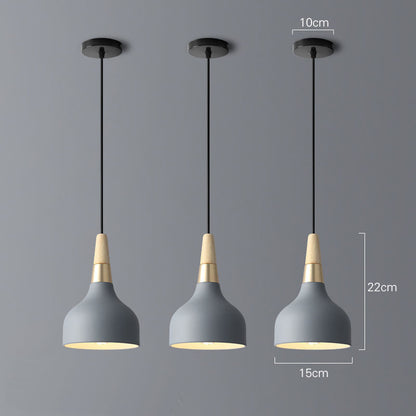 Gray concrete pendant light with brass accents and black cord, modern design.