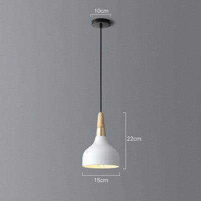White ceramic pendant light with wooden base and black cord, modern design.