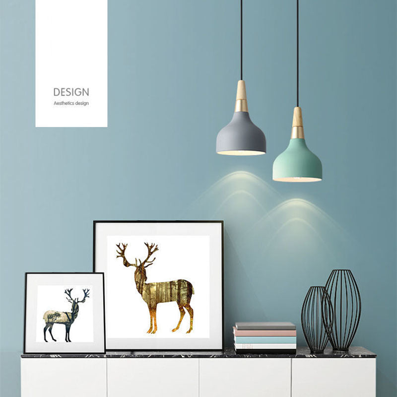 Modern dining room chandelier with three small pendant lights featuring gray teal shades and wooden accents