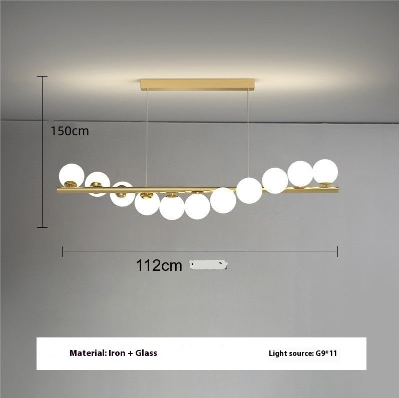 Gold bar pendant light with white glass spheres as light source in creative 3d long dining room chandelier design
