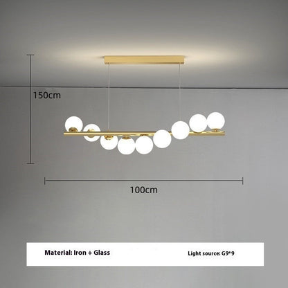 Gold bar pendant light with white glass spheres, iron and glass construction.