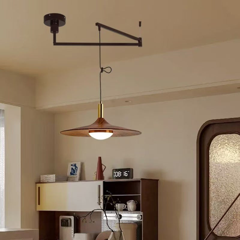 Modern copper pendant light with brass accents and a minimalist design.
