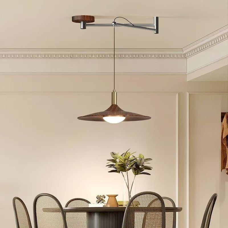 Modern industrial-style pendant light with a wooden accent and metal frame, featuring an adjustable arm for versatile lighting.