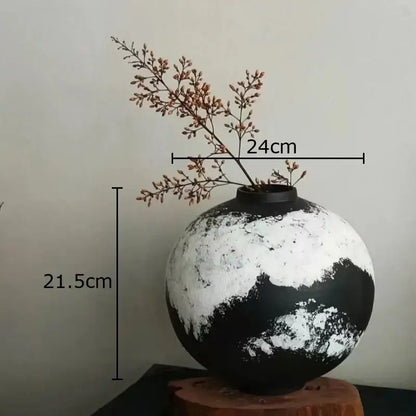 Rounded distressed black and white ink painting ceramic vase holding dried branches for living room decorbites decor