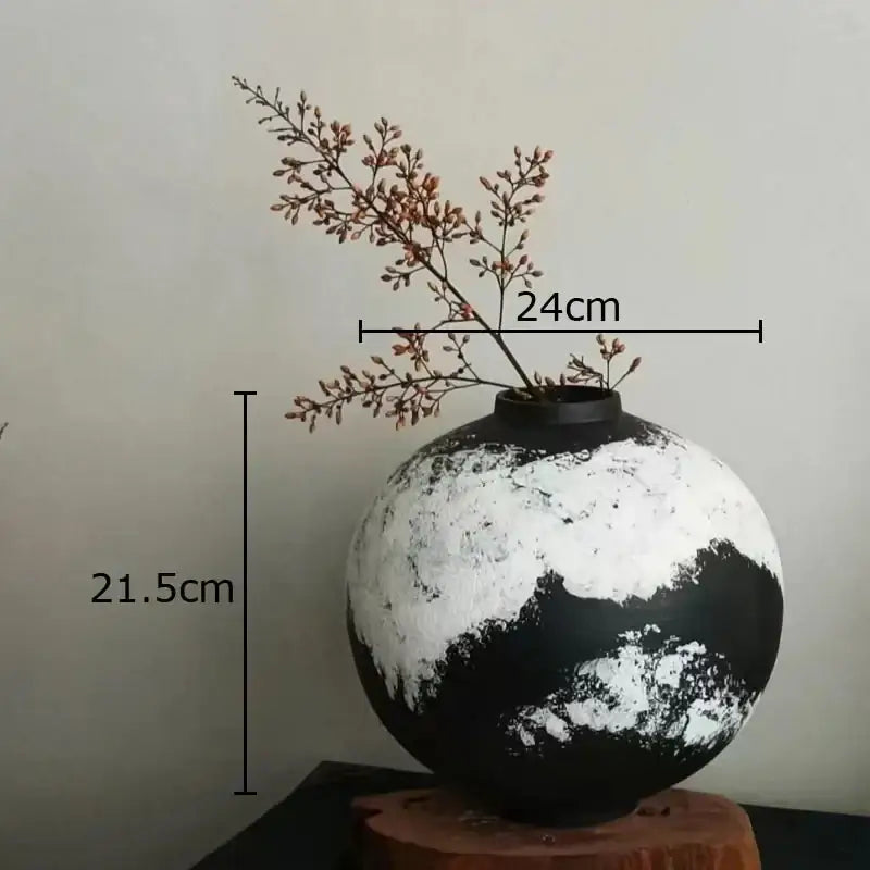 Rounded distressed black and white ink painting ceramic vase holding dried branches for living room decorbites decor