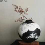 A round distressed black and white ink painting ceramic vase holding dried branches for living room decorbites decor