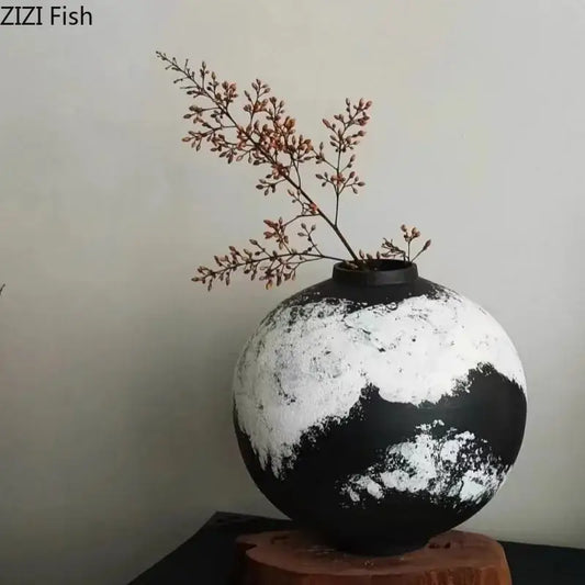 A round distressed black and white ink painting ceramic vase holding dried branches for living room decorbites decor