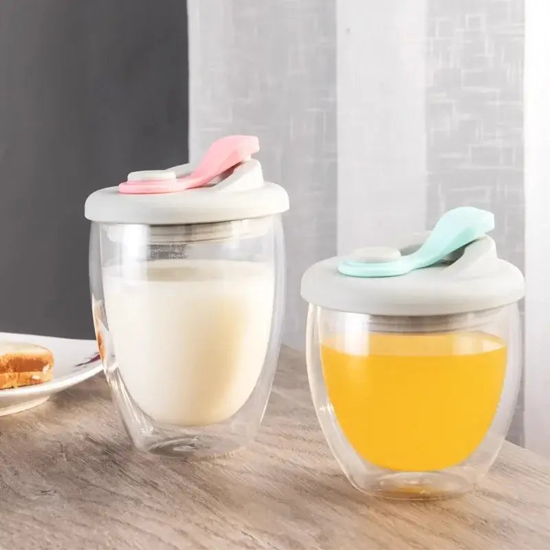 Clear double deck insulated glass mug with white lid and colorful silicone spoons for kitchen use