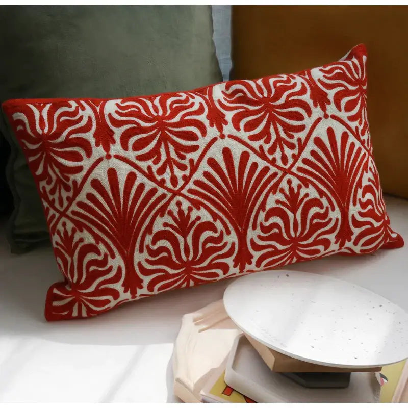 Rectangular double happiness embroidered red traditional lumbar pillow with bold floral and leaf patterns on textured fabric